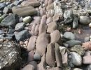Rows of broken rocks laid out as if a stone mason arranged them.