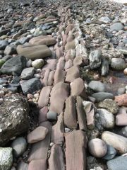 Rows of broken rocks laid out as if a stone mason arranged them.