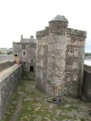 A stand alone prison inside a thick walled fortress.