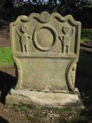 Torphican churchyard - 'Adam and Eve' carving carries over onto the edges of the stone.