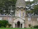 The pineapple stands 45' above the garden wall. These walls were heated to help the collection of exotic plants survive the Scottish weather.